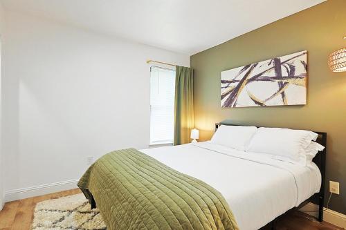 a bedroom with a large bed and a window at The Dallas Hub - Spacious 4BR - Prime location in Farmers Branch