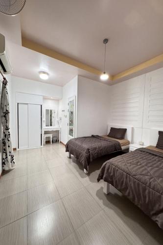 a large room with two beds and a desk at Ban Suan Suree Resort in Ban Thung Yao