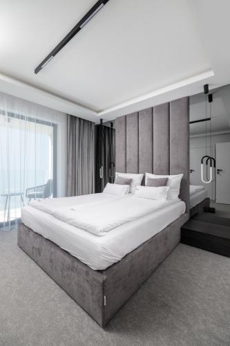 a bedroom with a large bed in a room at Aqua Bluemica ADULTS ONLY in Międzyzdroje