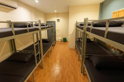 a row of bunk beds in a room at Sundiva Guest House in Patong Beach