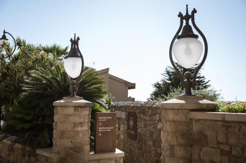 two street lights on a stone fence at Villa Dei Melograni Boutique Hotel in Cefalù