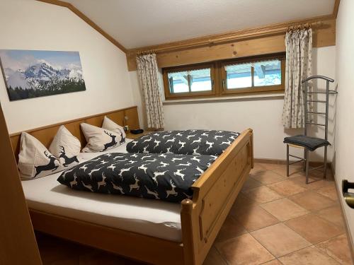 a bedroom with a bed and a ladder in it at Landhaus Brigitte in Obermaiselstein