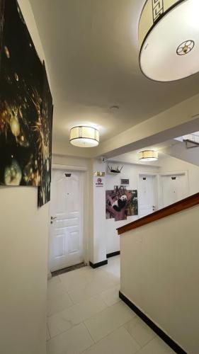 a room with a hallway with a counter and a door at Abaት Guest House in Addis Ababa