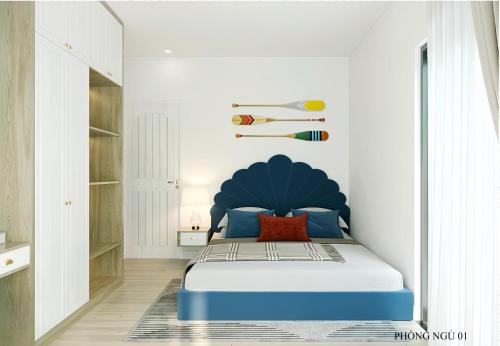 a bedroom with a blue bed in a white room at Bali Villa- Đối diện Tropicana Park - Novaworld Hồ Tràm in Ho Tram
