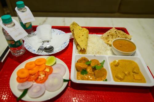 a tray of food with rice and vegetables on a table at Urvi Banquets & Guest House in kolkata