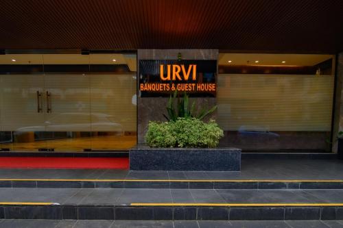 a store front of a building with a sign on it at Urvi Banquets & Guest House in kolkata
