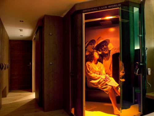 a woman sitting on a bunk bed in a room at Lifestyle Hotel eder in Maria Alm am Steinernen Meer