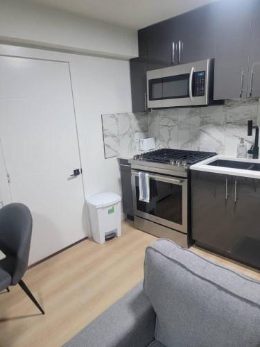 a kitchen with a stove and a microwave at Shiloh Residence in Edmonton