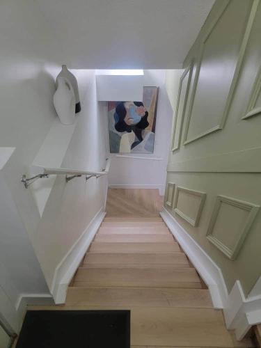 a staircase in a house with a painting on the wall at Shiloh Residence in Edmonton