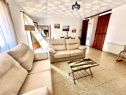 a living room with two couches and a table at Casa Vidal, Es Trenc, Campos in Campos