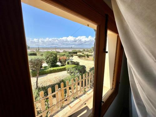 a window in a room with a view of a field at Casa Vidal, Es Trenc, Campos in Campos