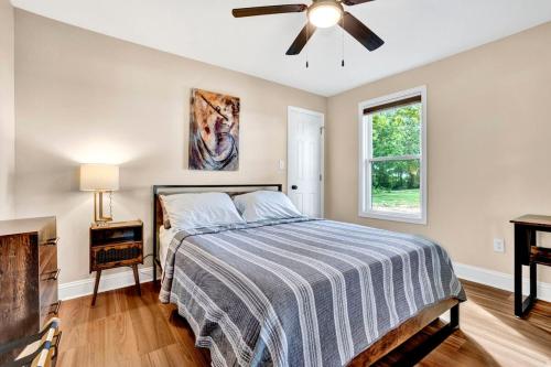 a bedroom with a bed and a ceiling fan at Welcome to Villa Rosa Farmhouse in Piedmont