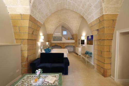 a living room with a couch and a bed in a room at Tenuta Monacelli Lecce in Lecce