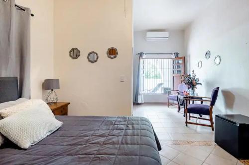 a bedroom with a bed and a table and chairs at Casa Praxedis in Santiago