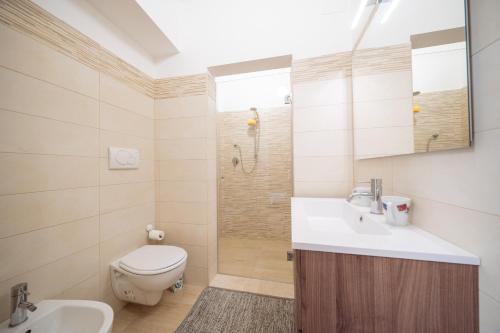 a bathroom with a toilet and a sink and a shower at Room Nabigi' - Centro Storico in Conversano