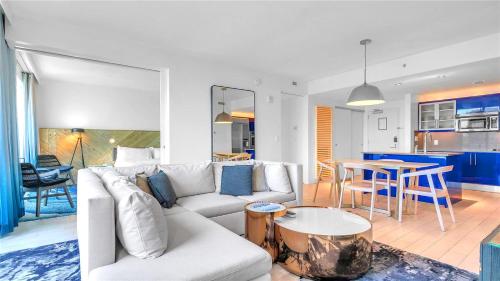 a living room with a white couch and a table at Exclusive Beachfront Condo at W Fort Lauderdale in Fort Lauderdale