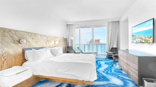 a hotel room with a bed and a large window at Exclusive Beachfront Condo at W Fort Lauderdale in Fort Lauderdale