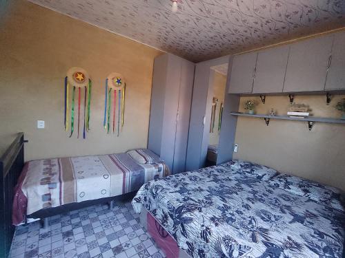 a bedroom with two beds and some decorations on the wall at Abrace a amazônia in Belém