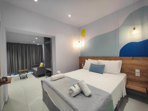 a bedroom with a large bed with two pillows on it at Corfu Port Studios in Mantoúkion