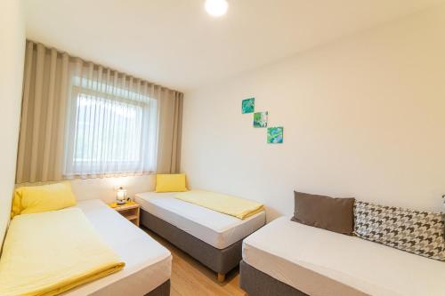 a room with two beds and a couch at Bauernhof Residence Hausergut with Ortler views, central and quiet position in Sluderno