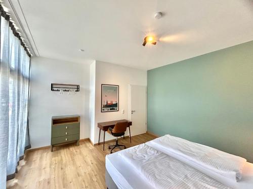 a bedroom with a bed and a desk in it at COZEE - Gemütliche Design-Wohnung bei München in Ismaning