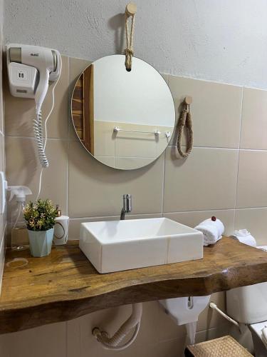 a bathroom with a white sink and a mirror at Chalé Caju Beach - Barra Grande Piauí in Barra Grande