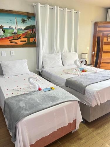 two beds sitting next to each other in a room at Chalé Caju Beach - Barra Grande Piauí in Barra Grande