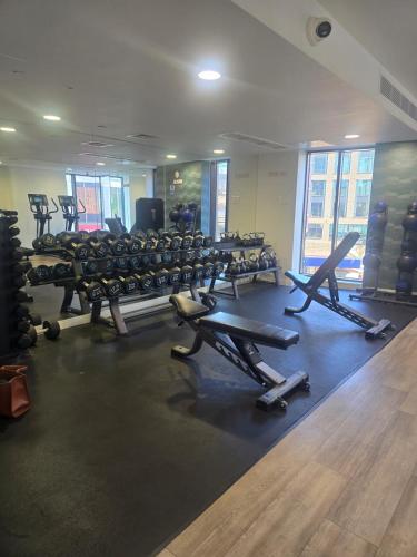 a gym with rows of exercise bikes and treadmills at Stylish & Cosy Central Bham Apt in Birmingham