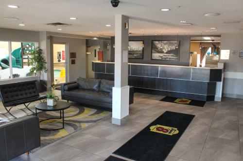 a lobby with a couch and a counter at Super 8 by Wyndham Edmonton South in Edmonton