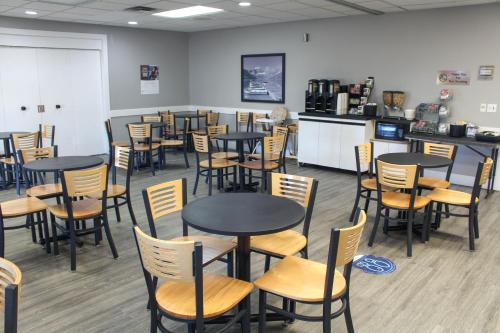 a restaurant with tables and chairs in a room at Super 8 by Wyndham Edmonton South in Edmonton