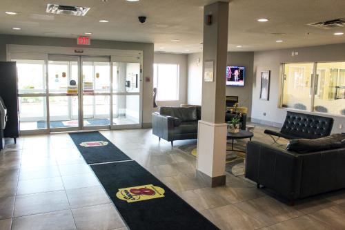a lobby with couches and chairs in a hospital at Super 8 by Wyndham Edmonton South in Edmonton