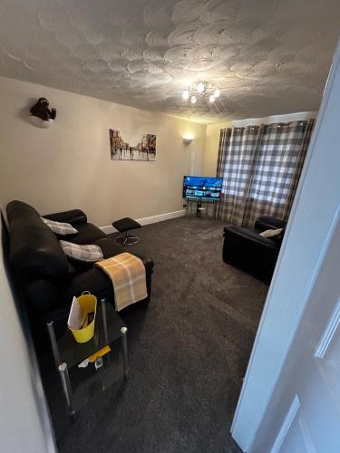 a living room with a couch and a table at Wessex Stays - Spacious 1 Bedroom Property in Willaston