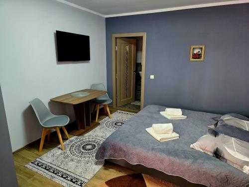 Un pat sau paturi într-o cameră la Casa Deluxe