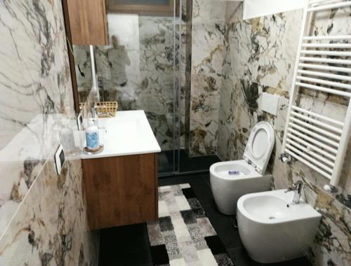 a bathroom with a sink and a toilet at Vlletta da Amare in Imperia