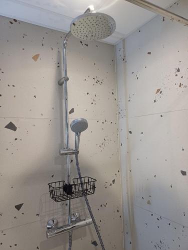a shower in a room with a wall covered in debris at Luise LuXe Suites in Tallinn