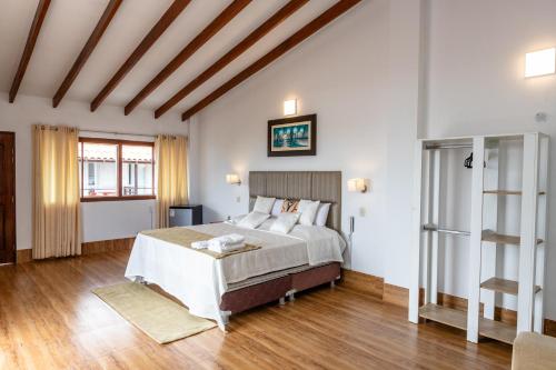 a bedroom with a bed and a wooden floor at Costa Beach in Zorritos