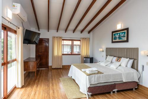 a bedroom with a bed and a flat screen tv at Costa Beach in Zorritos