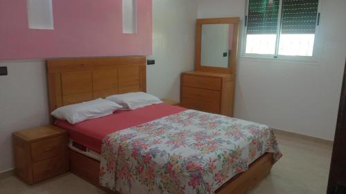 Una cama o camas en una habitación de تمراغت أݣادير