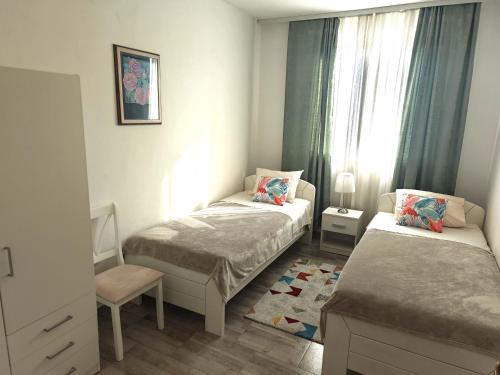 a small bedroom with two beds and a window at Apartments Tessa 77 in Medulin