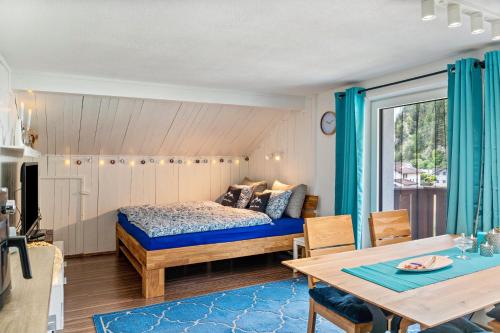 a bedroom with a bed and a dining table at Ferienwohnung Montana Amor in Prutz