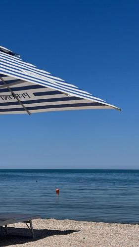 a boat sitting on the beach near the water at Edmond in Eforie Sud