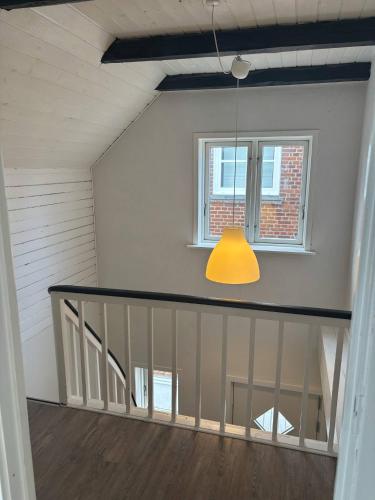 a room with a staircase and a yellow light at Private apartment near Billund in Grindsted