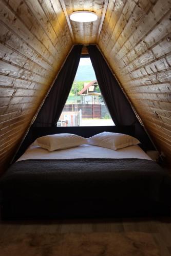 a bed in a tent with a window at PRIVATE PLACE Avrig adults only in Avrig