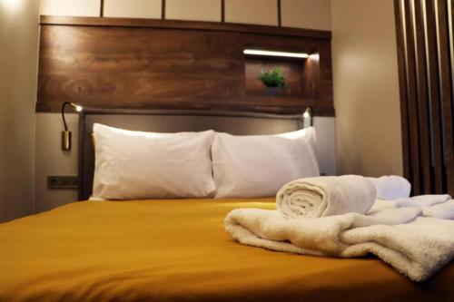 a bed with two towels on top of it at Superior Petit Studio in Mytilini