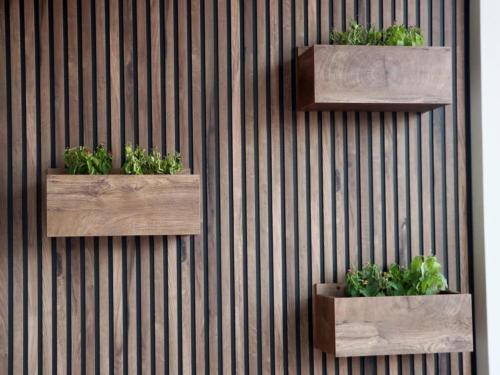 two wooden planters on a wall with plants at Superior Petit Studio in Mytilini