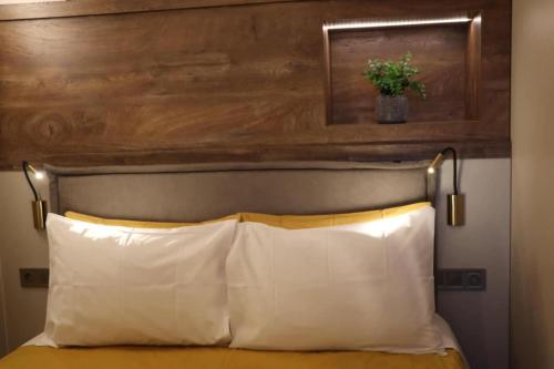 a headboard with a potted plant above a bed at Superior Petit Studio in Mytilini