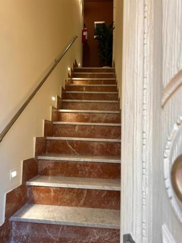 a staircase with brown stone steps with lights at Sarò rooms in Pietraperzia