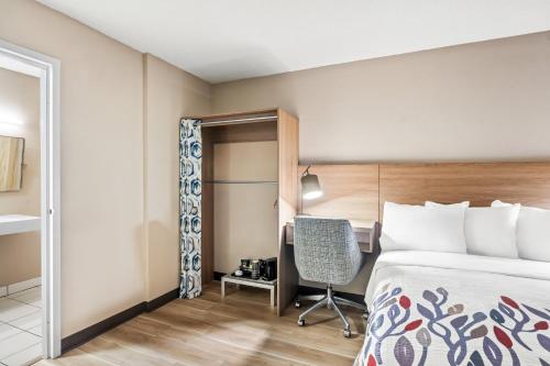 a hotel room with a bed and a chair at Red Roof Inn Perryville in Havre de Grace