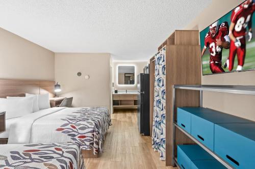 a hotel room with a bed and a tv at Red Roof Inn Perryville in Havre de Grace