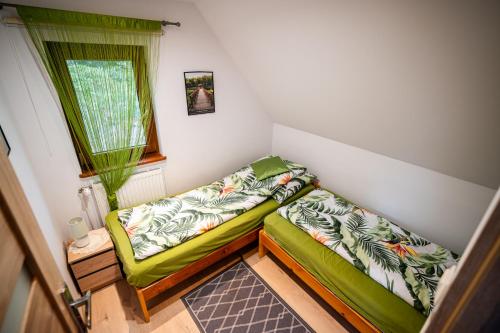 a small room with a bed and a window at Domek nad Oczkiem - Giżycko in Giżycko